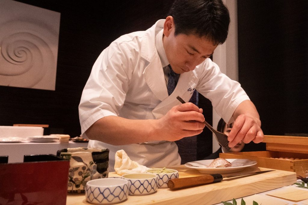 Master sushi chef preparing luxury dining Tokyo Japan